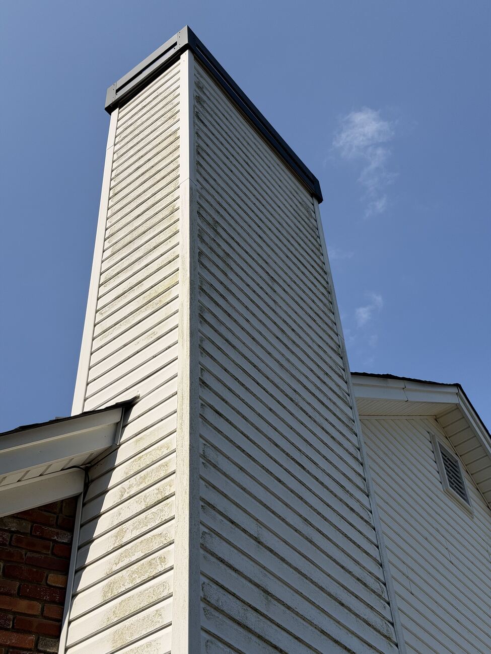Chimney siding before soft wash — dingy with organic staining