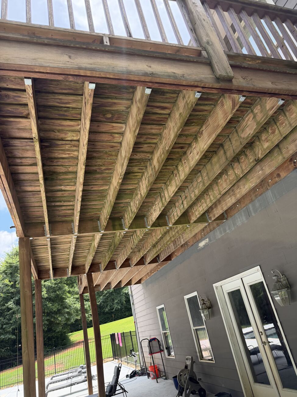 Underside of a wood deck before cleaning